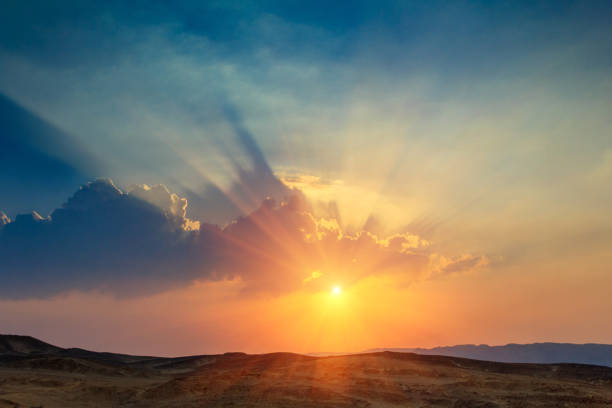Landscape of beautiful sunset in the desert. Sinai Peninsula. Landscape of beautiful sunset in the desert. View of high sandstone hills and dramatic cloudy sky. Sinai Peninsula. orange sunset stock pictures, royalty-free photos & images