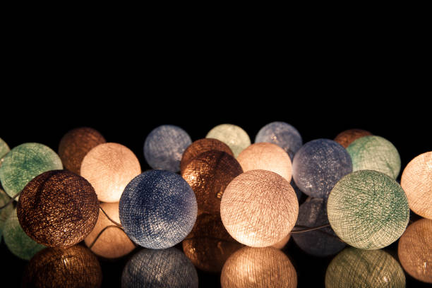 colorful glowing balls on a black background. glowing garland at night. colorful circles on the background. - lamp lighting equipment light reading imagens e fotografias de stock