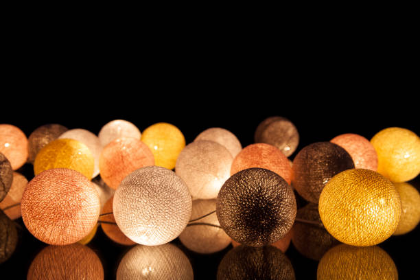 colorful glowing balls on a black background. glowing garland at night. colorful circles on the background. - lamp lighting equipment light reading imagens e fotografias de stock