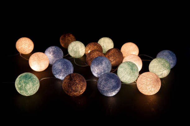 colorful glowing balls on a black background. glowing garland at night. colorful circles on the background. - lamp lighting equipment light reading imagens e fotografias de stock