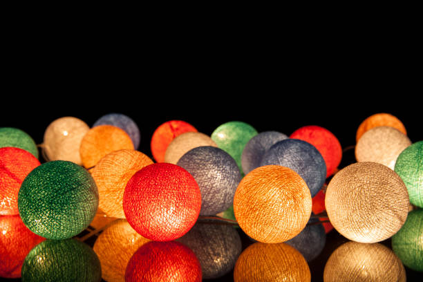 colorful glowing balls on a black background. glowing garland at night. colorful circles on the background. - lamp lighting equipment light reading imagens e fotografias de stock