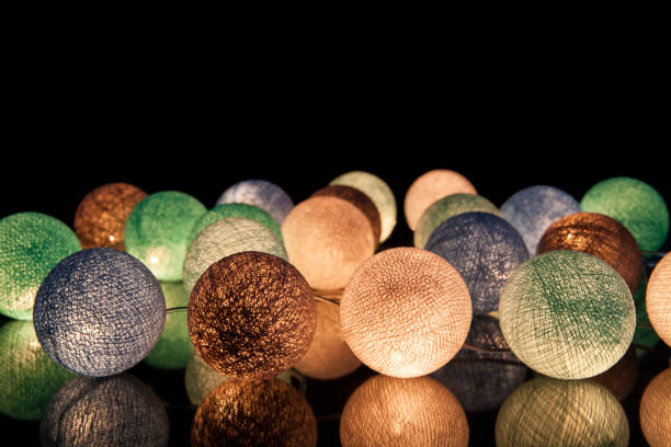 colorful glowing balls on a black background. glowing garland at night. colorful circles on the background. - lamp lighting equipment light reading imagens e fotografias de stock