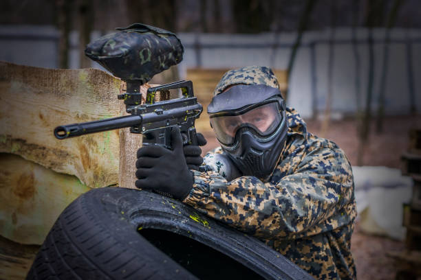 istock Paintball player takes aim, hides and shooting. Man wearing protective equipment 952867256