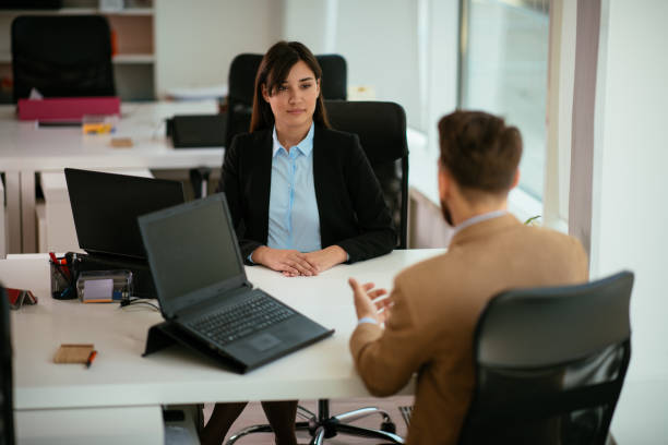 istock Young colleagues talking to each other in the office 952870272