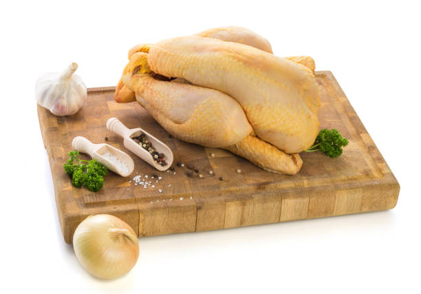 Raw chicken ready to be cooked on wooden cutting board