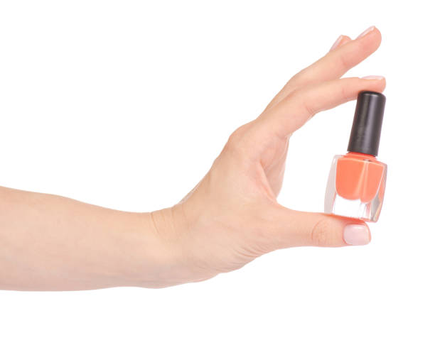 istock Orange nail polish in hand 952877566