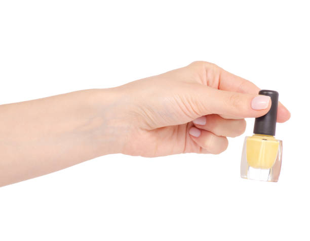 istock Yellow nail polish in hand 952877574