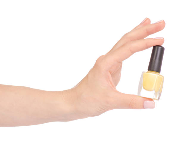 istock Yellow nail polish in hand 952877598