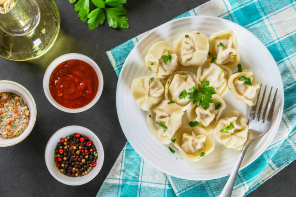 istock Homemade ready dumplings on a gray concrete table. 952893048