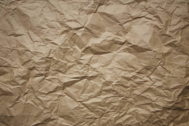 istock Brown rough crumpled recycled paper texture 952893624