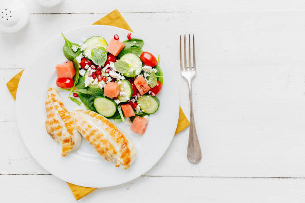 istock Dinner with salad and chicken on plate 952897544