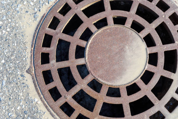 istock Rain Manhole Cover with Dirty Water 952898510