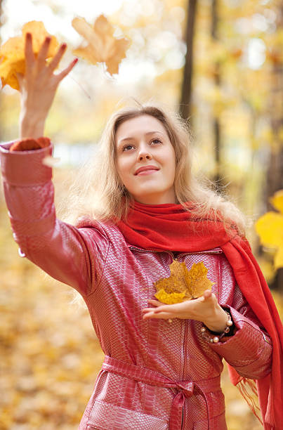 istock Young woman throwing leaves 95289933