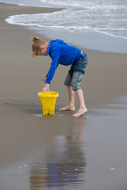 istock Girl with bucket on beach 95290237