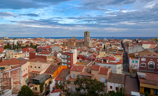 View of the old town Malgrat de Mar, Spain, from the hill with the Church of St Nicolau in the middle and Mediterranean sea in background
