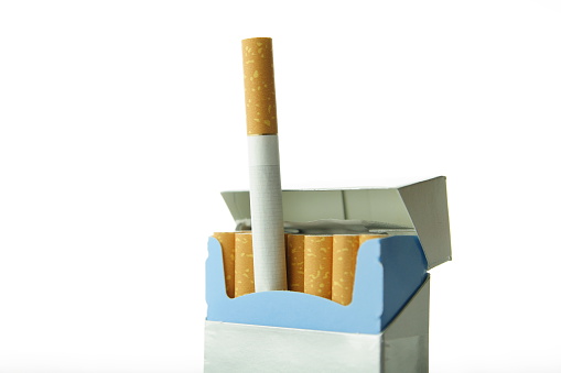 A close up of a cigarette butt on a blue background