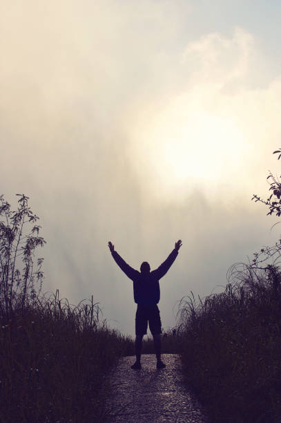 istock Victory Pose Male on Path in clouds looking up 952923298