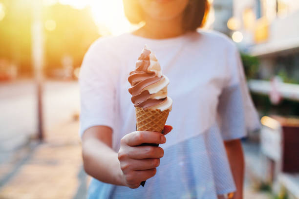 cheerful woman on the street eating ice cream walk summer. High quality photo