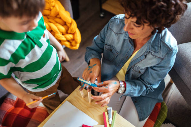 istock Mother and son coloring together 952944120