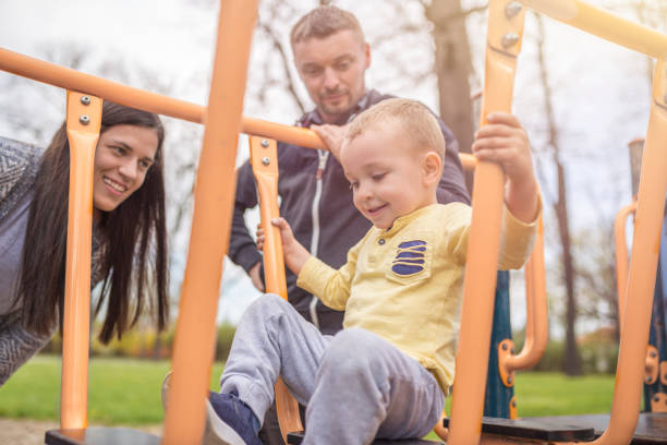 istock Parents having fun with their child in park 952946760