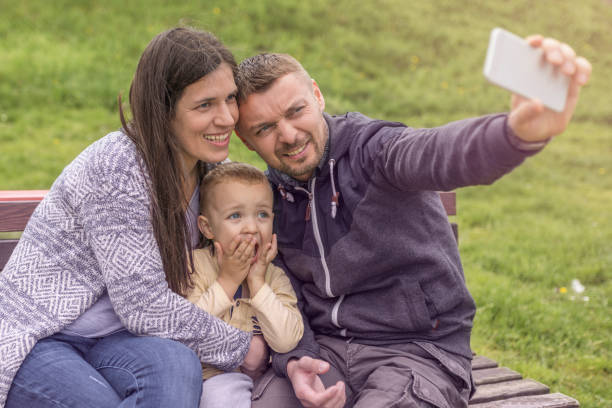 istock Parents having fun with their child in park 952947076