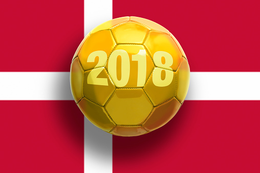Golden soccer ball on flags background..
