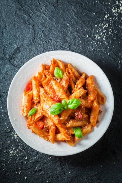 istock Delicious penne bolognese with parmesan and basil 952958246