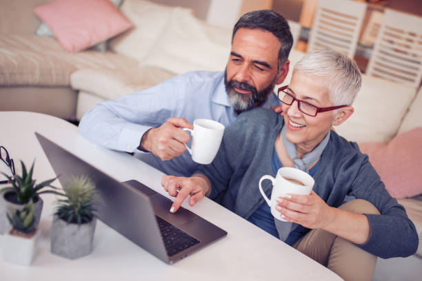 istock Happy mature couple using laptop at home 952958732