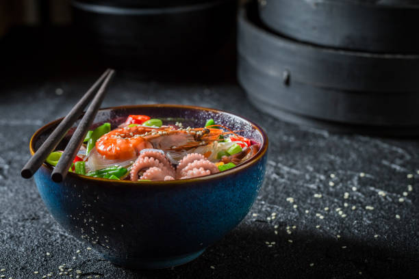 istock Seafood noodle with octopus and shrimps on black rock 952958840