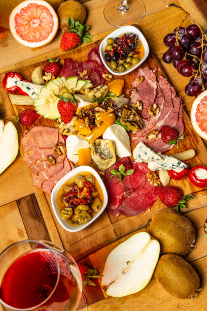 istock Cold meat appetizers with fruits, cheese and wine 952962518
