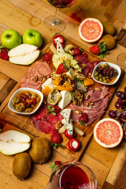 istock Cold meat appetizers with fruits, cheese and wine 952962556