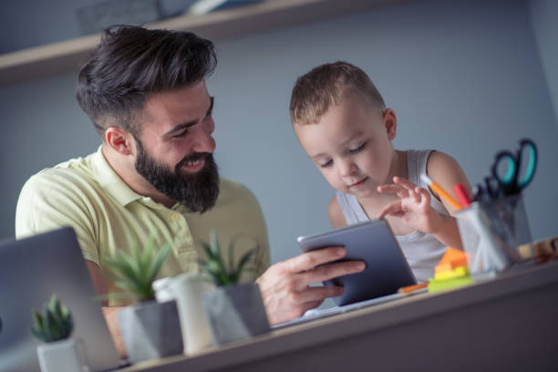 istock Young father with his little son working from home 952962650