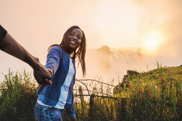 istock Pulling and holding hands at Victoria Falls Lookout 952966450