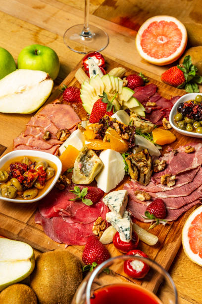 istock Cold meat appetizers with fruits, cheese and wine 952966542