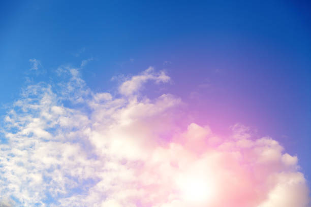 istock clouds against a blue sky with rays of the sun 952970096