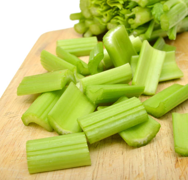 istock Fresh sliced green celery on wooden background 952980314
