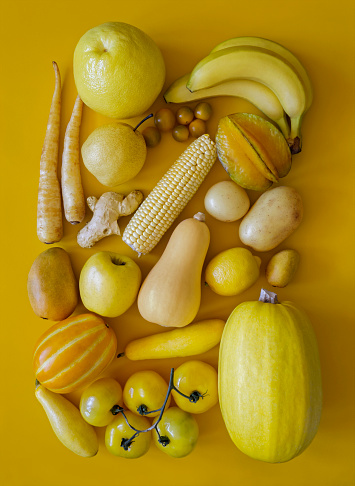 Looking down on monochrome yellow fruits and vegetables