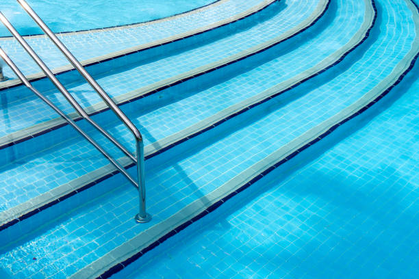 istock Swimming pool with stair at hotel close up. 952980940
