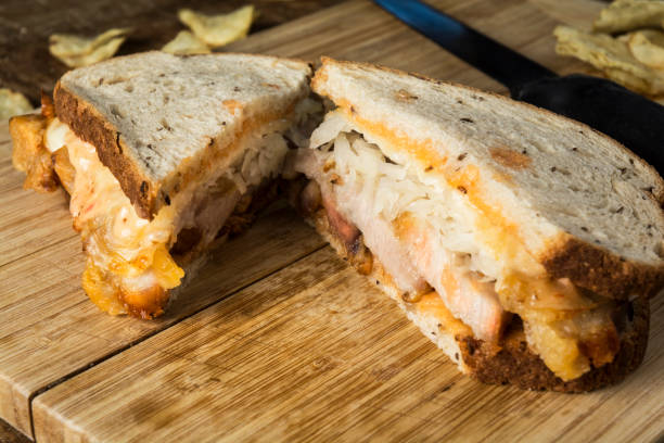 istock Gourmet Ruben Sandwich On Wooden Cutting Board 952981328