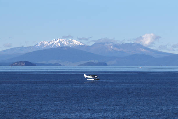 Lake Taupo and volcanoes Plane over Lake Taupo, volcanoes of Tongariro National Park in the background, New Zealand tongariro national park photos stock pictures, royalty-free photos & images