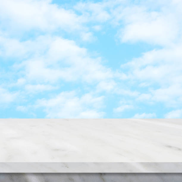 istock Empty white marble table over blue sky nature background, product display montage 952984600