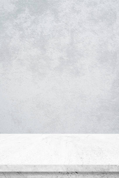 istock Empty white cement table over gray cement wall background, banner, table top, shelf, counter design for product display montage 952984794