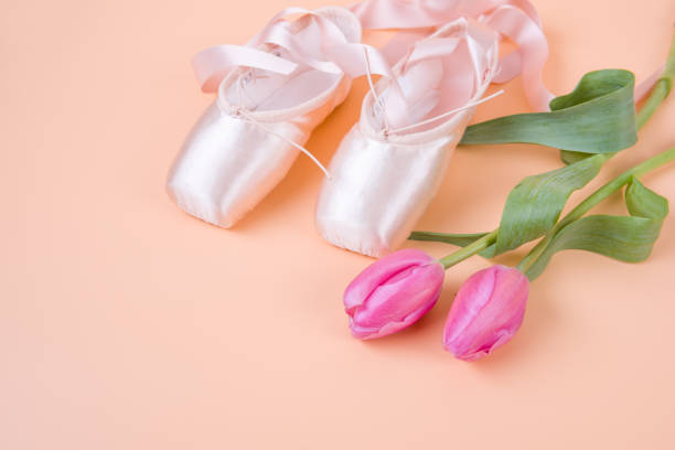 istock Ballet shoes and tulips on yellow background 952987182