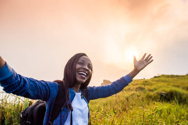 istock Happy woman with arms raised at sunrise 952988536