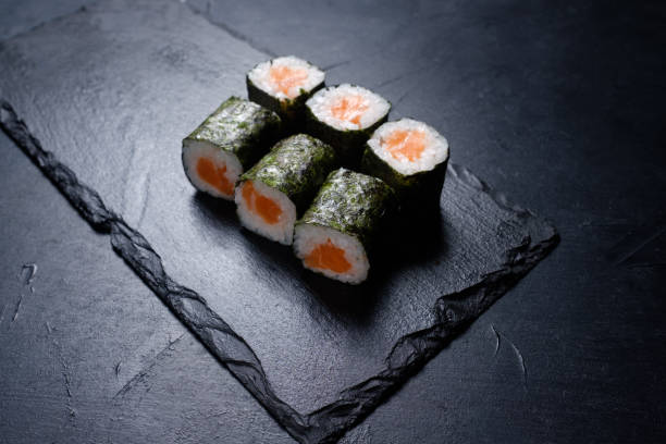 istock sushi salmon rolls dark background asian cuisine 953002184