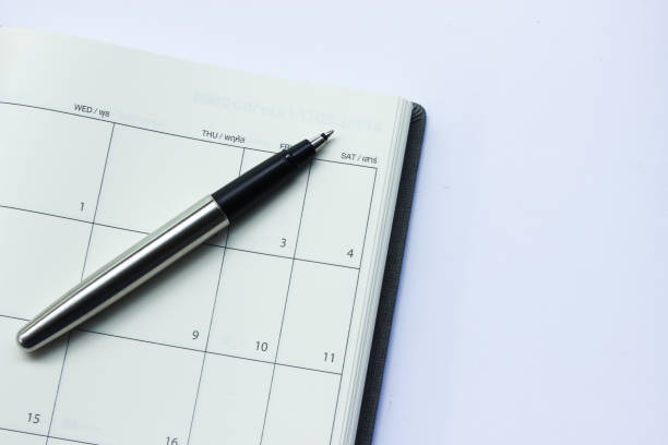 istock Pen on Calendar Planner Isolated on the White Background 953002326