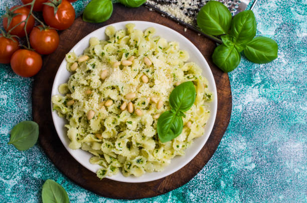 Traditional Italian pasta with pesto Traditional Italian pasta with pesto in a plate on the table. Selective focus. kosher starter recipes stock pictures, royalty-free photos & images