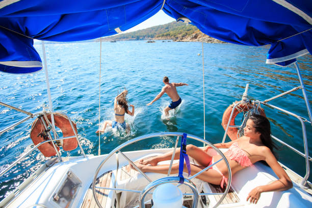istock Young people jumping from yacht 953009800