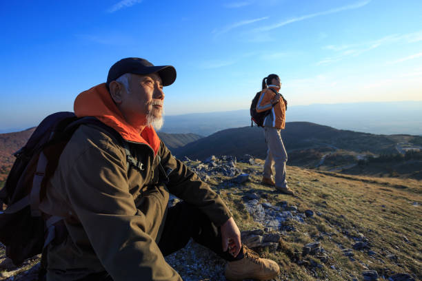 istock Senior backpacker sitting on top mountain and resting 953009822