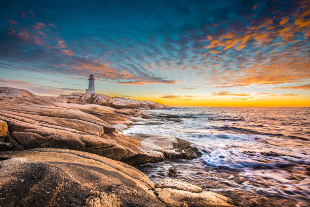 Peggy's cove lighthouse sunset ocean view landscape in Halifax, Nova Scotia stock photo